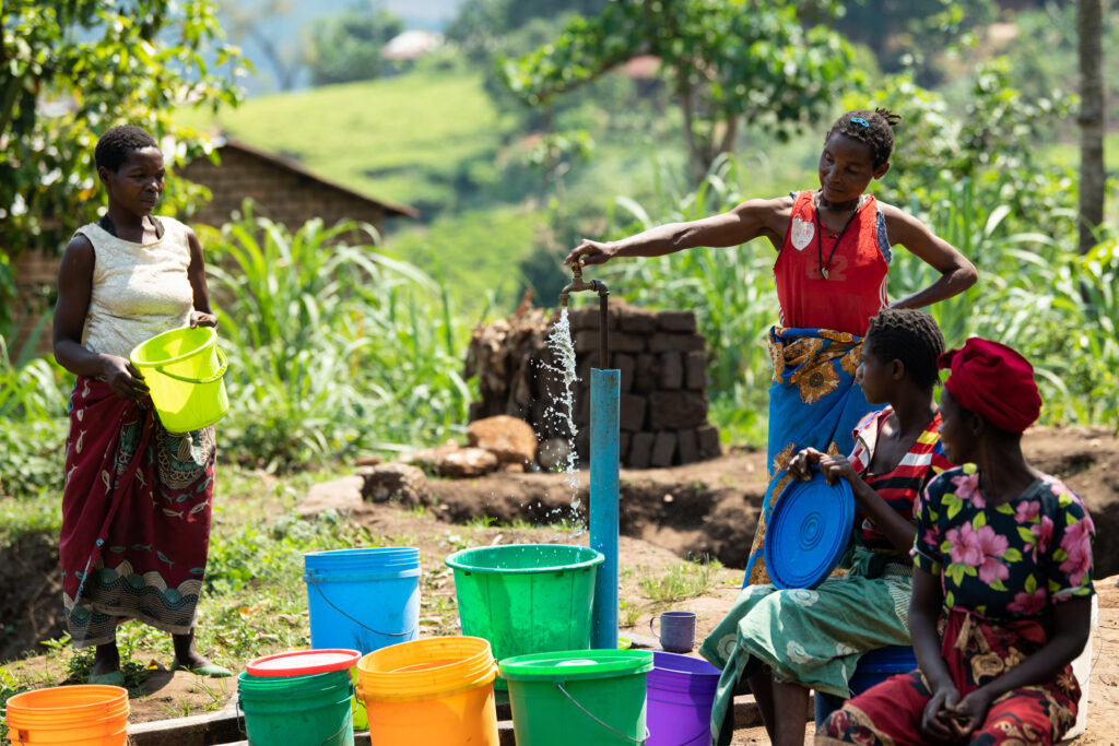 This image has an empty alt attribute; its file name is Women-draw-water-from-a-wtaer-distribution-site-via-a-tap-in-Thyolo-southern-Malawi-on-Tuesday-26-September-2023-3-1024x683.jpg